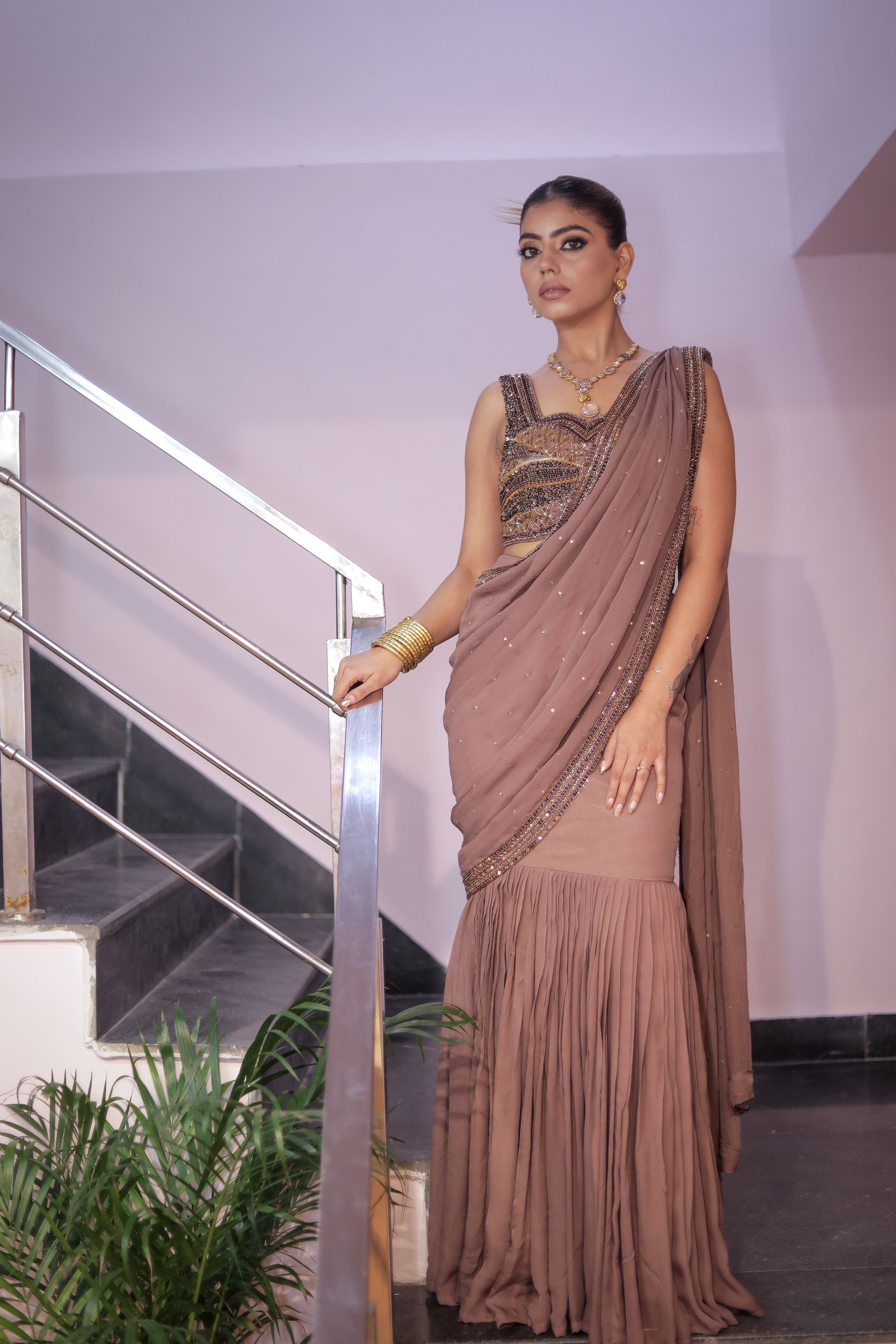 Nudish pink heavy blouse with drape saree