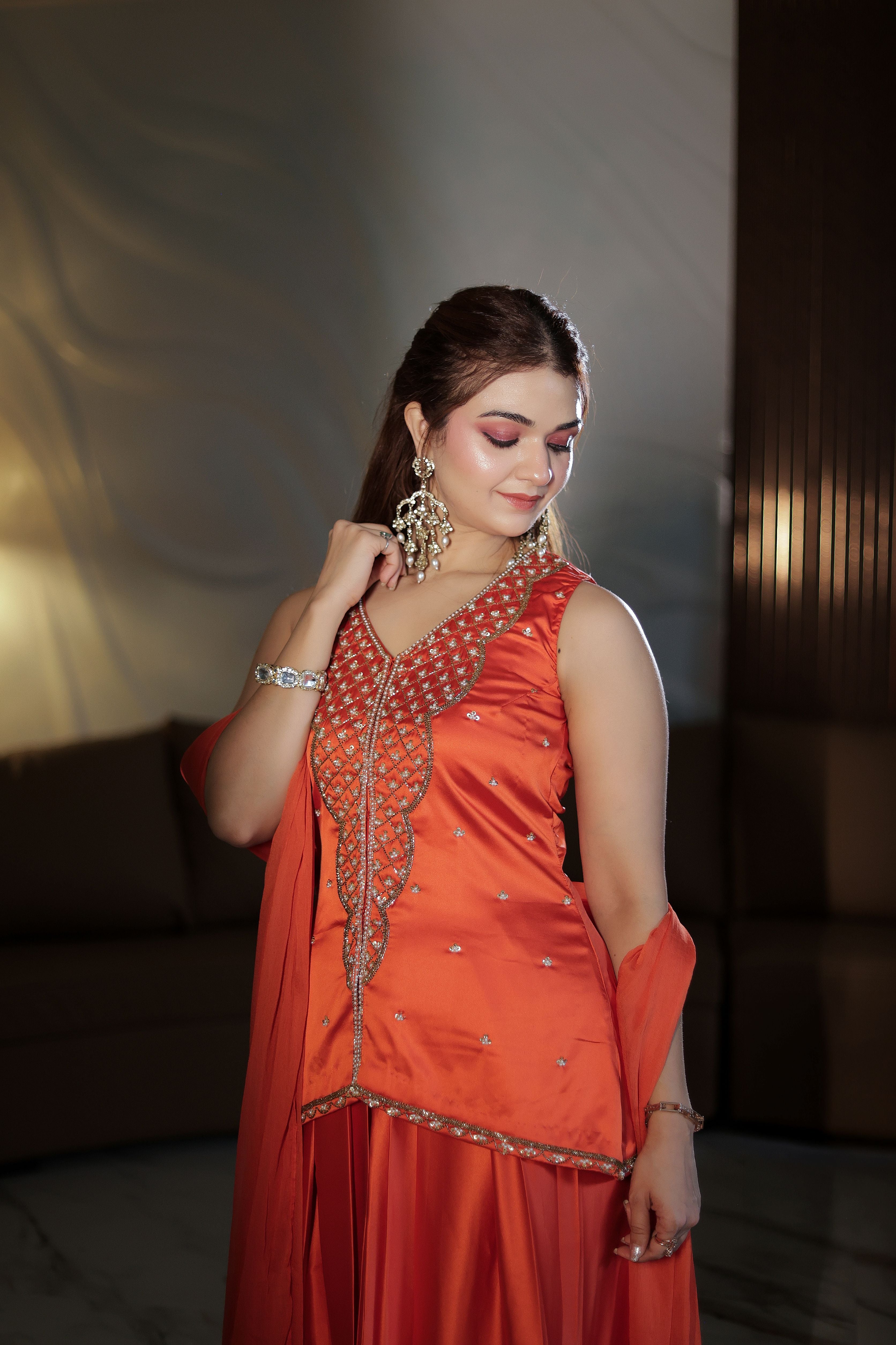 Orange hand embroidered pearl work suit with dhoti