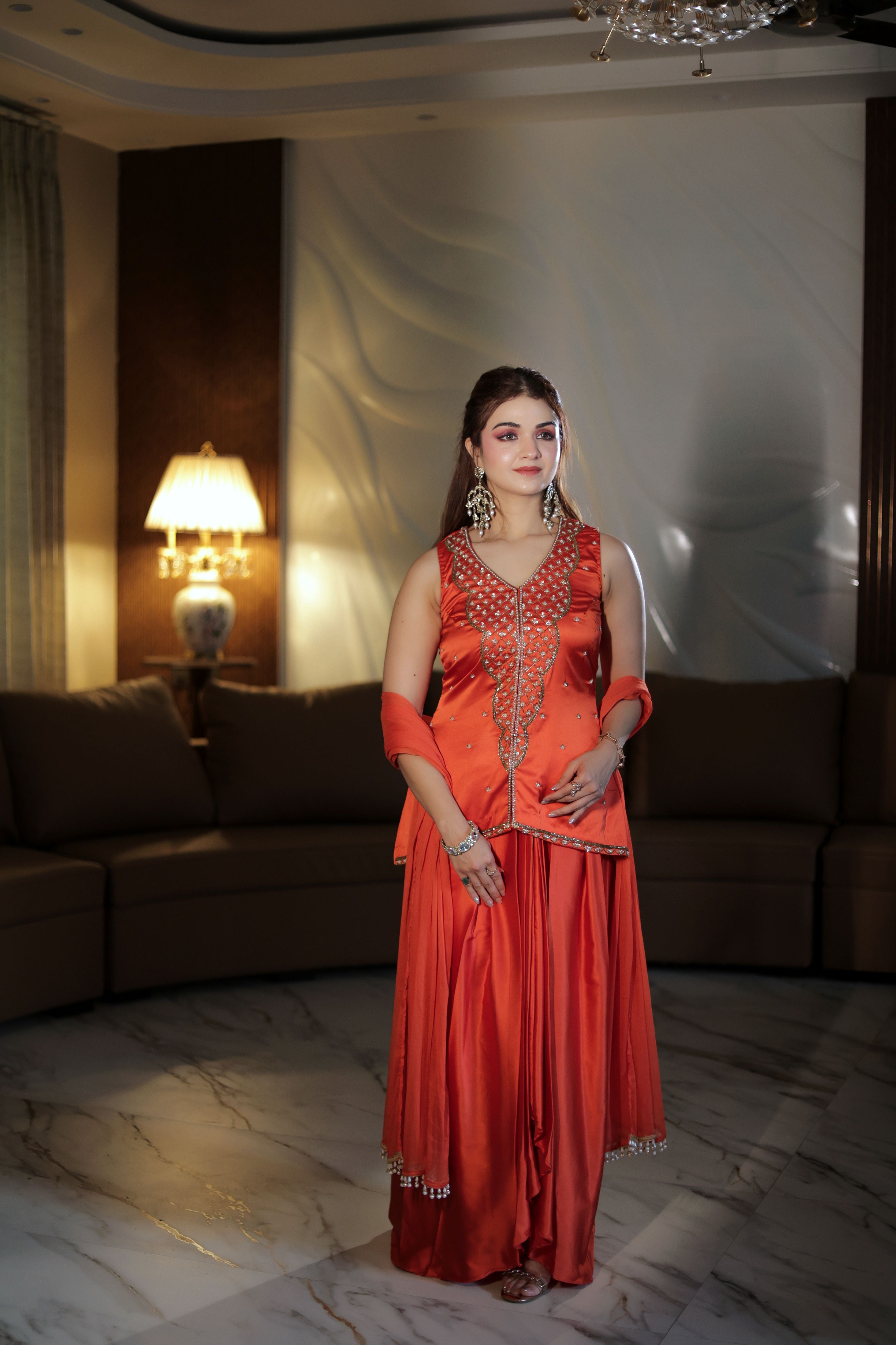 Orange hand embroidered pearl work suit with dhoti
